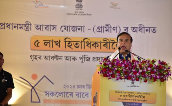 Chief Minister Dr. Himanta Biswa Sarma is speaking while  presenting sanction letters to the beneficiaries for houses under...